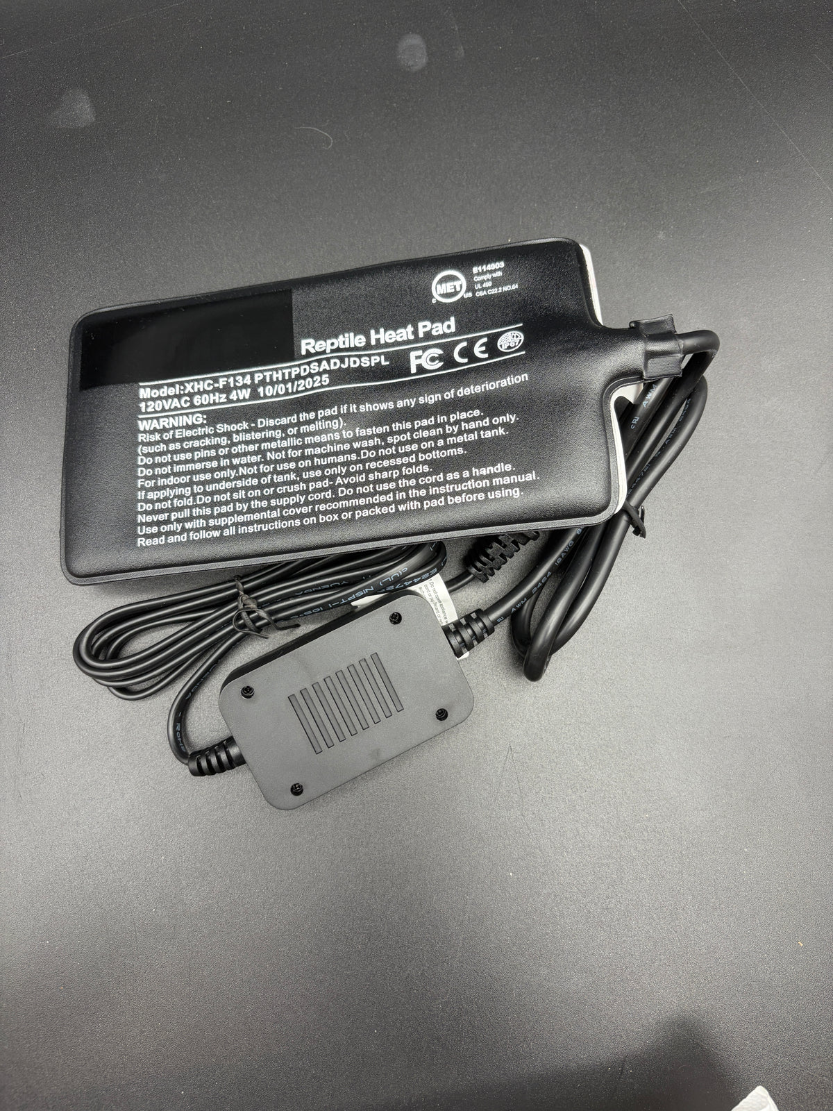 4 by 7 inch heat pad showing XHC-F134 model label and 4 watt electrical rating